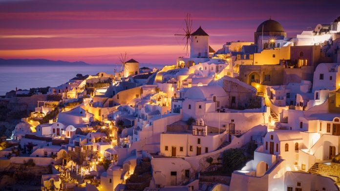 Dramatic Sunset in Mediterranean Town of Oia, Santorini, Greece,