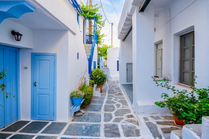 4 Greek Islands That Should Be on Your Bucket List Picturesque Naousa town street on Paros island, Greece