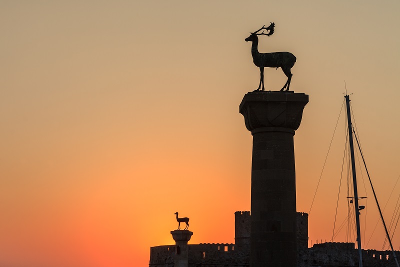 sunrise in Mandraki harbor. Rhodes, Greece