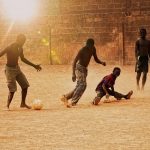 golden-hour-playing-football-during-sunset