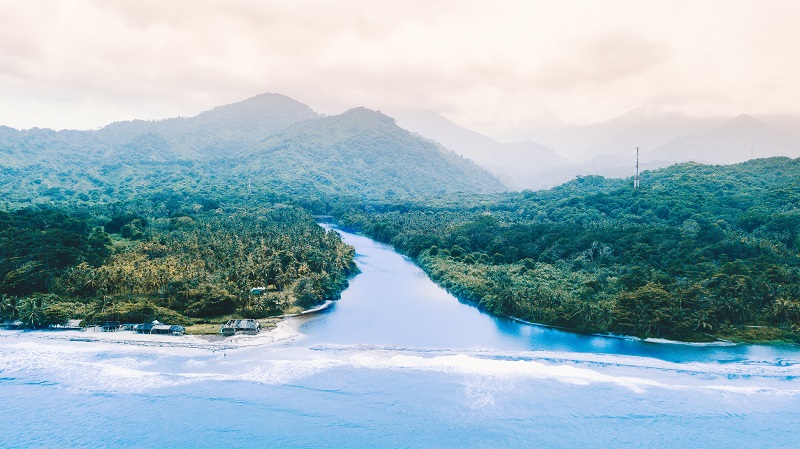 A freshwater river meets the sea on the Caribbean coast of Colom