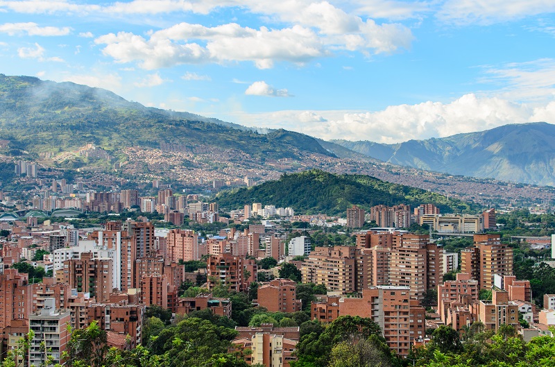 red-brick-buildings-on-lush-green-mountains-under