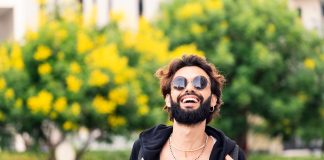 stylish student with sunglasses laughing happy