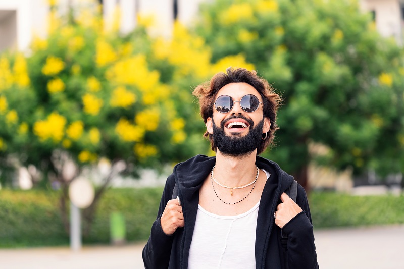 stylish student with sunglasses laughing happy