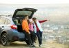 Family standing near car and enjoying nature.